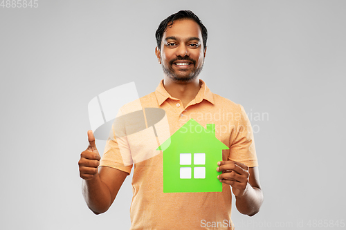 Image of indian man with green house showing thumbs up