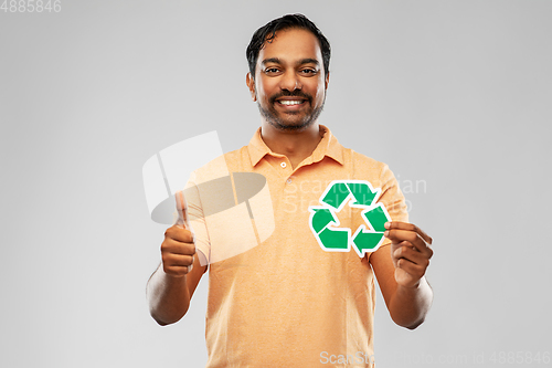 Image of smiling indian man holding green recycling sign