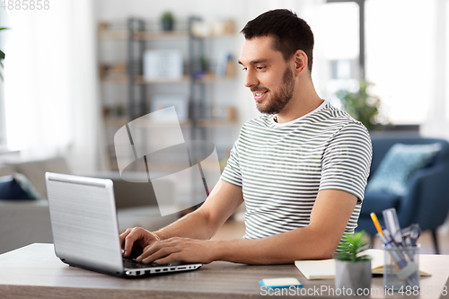 Image of man with laptop working at home office