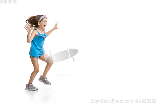 Image of Happy little caucasian girl jumping and running isolated on white background