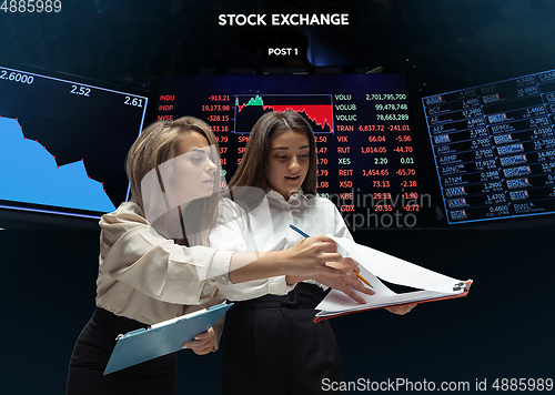 Image of Nervous tensioned investors analyzing crisis stock market with charts on screen on background, falling stock exchange