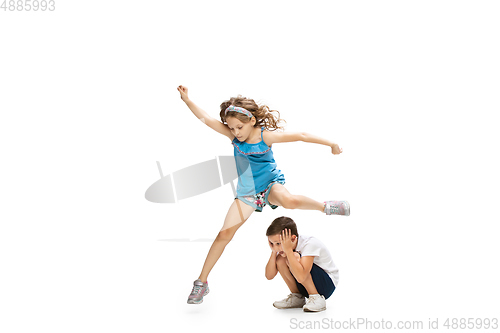 Image of Happy little caucasian girl and boy jumping and running isolated on white background