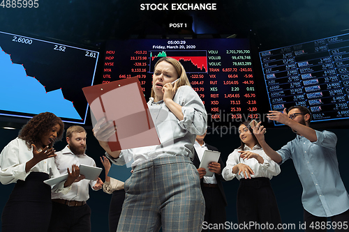 Image of Nervous tensioned investors analyzing crisis stock market with charts on screen on background, falling stock exchange