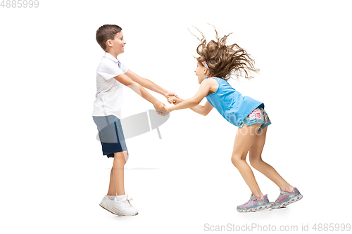 Image of Happy little caucasian girl and boy jumping and running isolated on white background