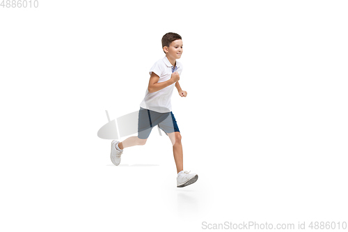 Image of Happy little caucasian boy jumping and running isolated on white background