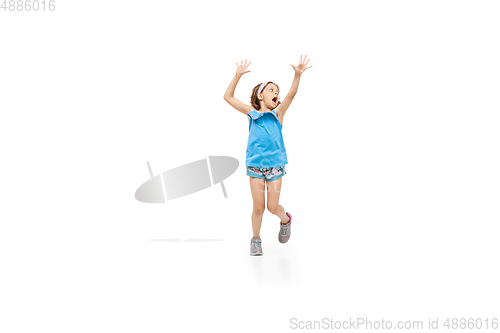 Image of Happy little caucasian girl jumping and running isolated on white background