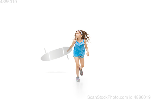 Image of Happy little caucasian girl jumping and running isolated on white background