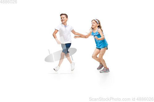 Image of Happy little caucasian girl and boy jumping and running isolated on white background