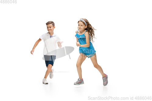 Image of Happy little caucasian girl and boy jumping and running isolated on white background