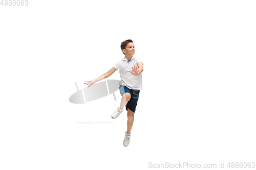 Image of Happy little caucasian boy jumping and running isolated on white background