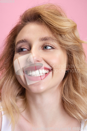 Image of Caucasian young woman\'s portrait isolated on pink studio background. Beautiful female model. Concept of human emotions, facial expression, sales, ad, youth culture.