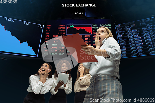 Image of Nervous tensioned investors analyzing crisis stock market with charts on screen on background, falling stock exchange