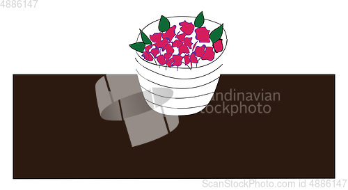 Image of Simple picture of a flower pot with pink flowers on a brown tabl