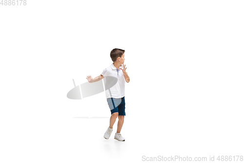 Image of Happy little caucasian boy jumping and running isolated on white background