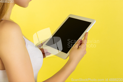 Image of Caucasian young girl\'s portrait isolated on yellow studio background. Beautiful female model. Concept of human emotions, facial expression, sales, ad, youth culture.