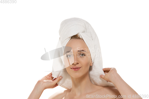 Image of Beauty Day. Woman wearing towel doing her daily skincare routine. Portrait isolated on white studio background