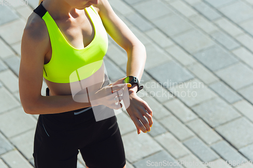 Image of Female runner, athlete training outdoors in summer\'s sunny day.