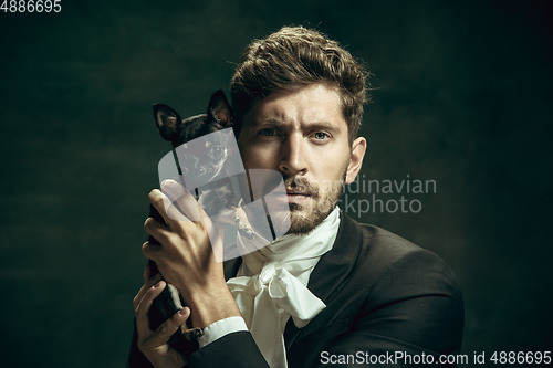 Image of Young man as Dorian Gray on dark background. Retro style, comparison of eras concept.