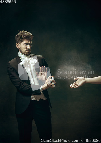 Image of Young man as Dorian Gray on dark background. Retro style, comparison of eras concept. Healthcare, prevention spread of pandemic. Stay safe.