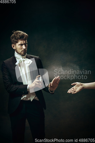 Image of Young man as Dorian Gray on dark background. Retro style, comparison of eras concept. Healthcare, prevention spread of pandemic. Stay safe.