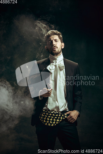 Image of Young man as Dorian Gray on dark background. Retro style, comparison of eras concept.