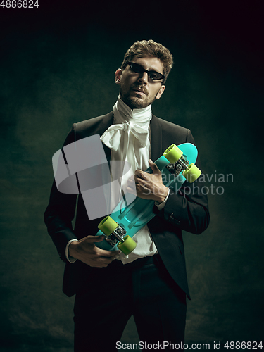 Image of Young man as Dorian Gray on dark background. Retro style, comparison of eras concept.