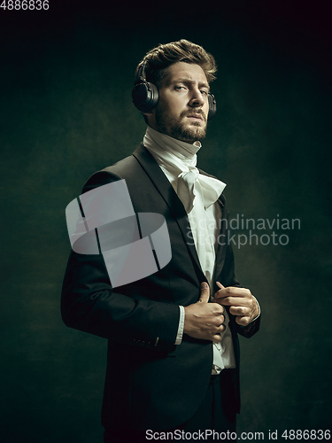 Image of Young man as Dorian Gray on dark background. Retro style, comparison of eras concept.