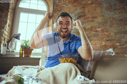 Image of Lazy man living the whole life in his bed surrounded with messy