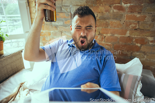 Image of Lazy man living the whole life in his bed surrounded with messy