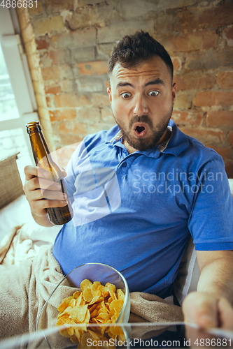 Image of Lazy man living the whole life in his bed surrounded with messy