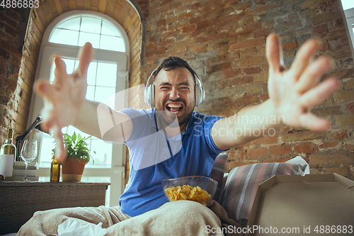 Image of Lazy man living the whole life in his bed surrounded with messy