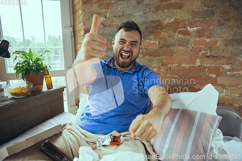 Image of Lazy man living the whole life in his bed surrounded with messy