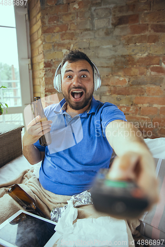 Image of Lazy man living the whole life in his bed surrounded with messy