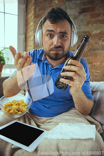 Image of Lazy man living the whole life in his bed surrounded with messy