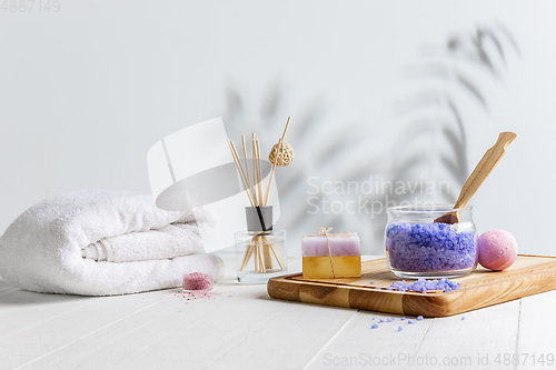 Image of Beautiful spa composition on massage table in wellness center, copyspace, leaves\' shadow