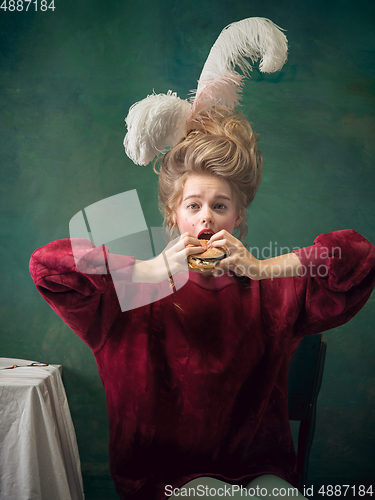 Image of Young woman as Marie Antoinette on dark background. Retro style, comparison of eras concept.