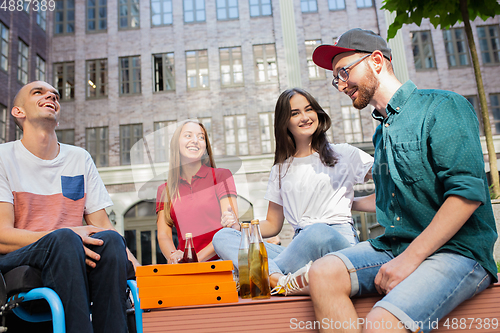 Image of Group of friends taking a stroll on city\'s street in summer day