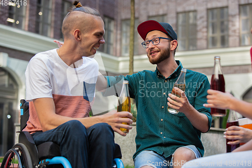 Image of Two friends taking a stroll on city\'s street in summer day