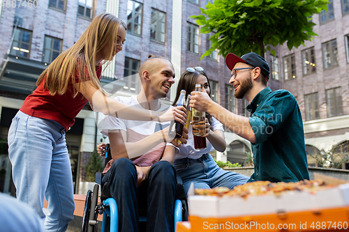 Image of Group of friends taking a stroll on city\'s street in summer day