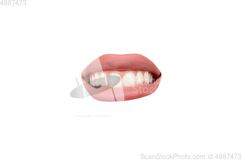 Image of Close up view of female mouth wearing nude lipstick isolated over white studio background