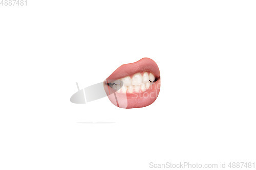 Image of Close up view of female mouth wearing nude lipstick isolated over white studio background