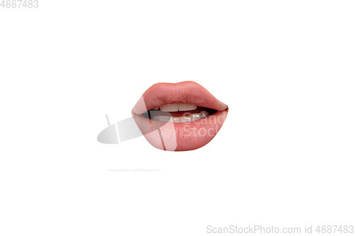 Image of Close up view of female mouth wearing nude lipstick isolated over white studio background