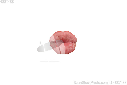 Image of Close up view of female mouth wearing nude lipstick isolated over white studio background