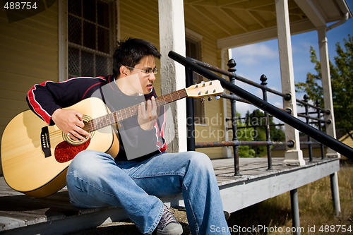 Image of Asian playing guitar