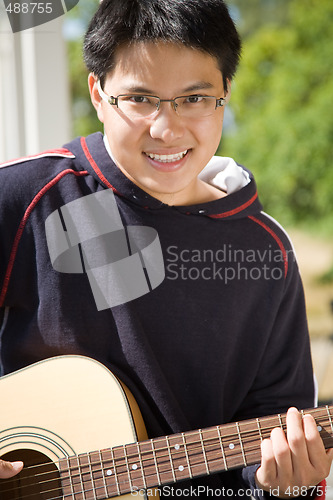 Image of Young asian guitar player
