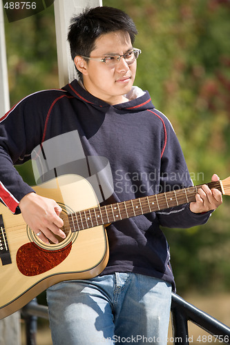 Image of Young asian guitar player