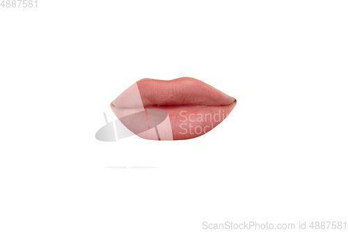 Image of Close up view of female mouth wearing nude lipstick isolated over white studio background