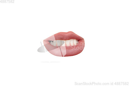 Image of Close up view of female mouth wearing nude lipstick isolated over white studio background