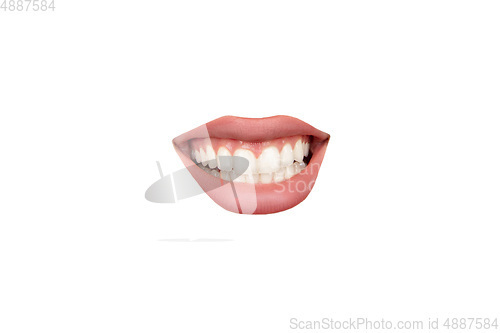 Image of Close up view of female mouth wearing nude lipstick isolated over white studio background