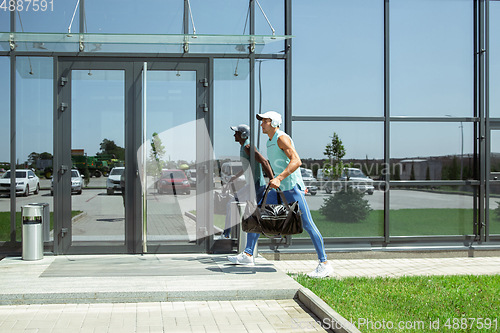 Image of Sports man against modern glassed building, airport in megapolis